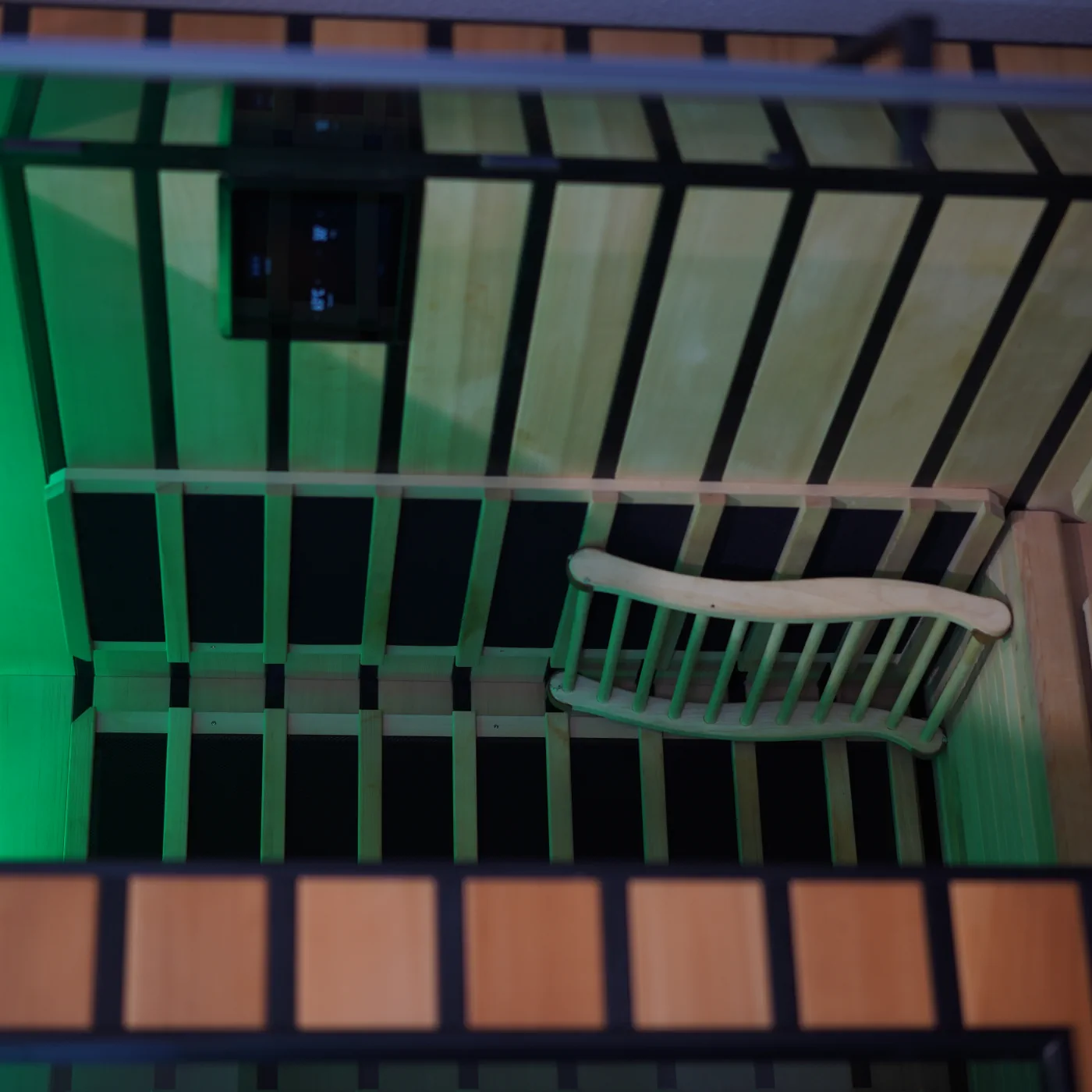 The Sparc Up infrared sauna lit in green